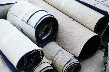 Close up on stacking carpet rolls for home improvement