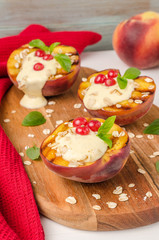 Delicious grilled peaches dessert with yogurt, gooseberries and mint leaves