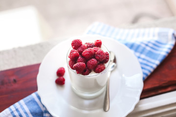 healthy breakfast : yogurt and fresh raspberries