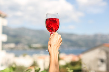 glass of strawberry juice on background of sea and mountains