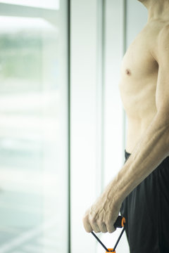 Man exercising nude torso
