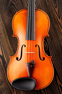 Close up of a violin on wooden table