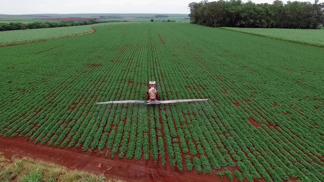 Aerial drone dolly in of the old tractor pulverizing a peanut planting intial stage