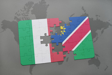 puzzle with the national flag of italy and namibia on a world map background.