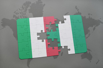 puzzle with the national flag of italy and nigeria on a world map background.