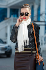 Fashion autumn woman in leather jacket outdoors