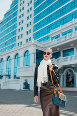 Fashion autumn woman in leather jacket outdoors