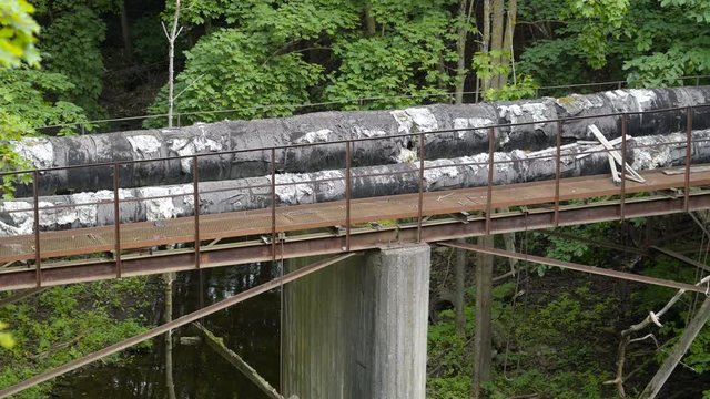 The big black pipelines on the forest found in the border of Russia and Estonia
