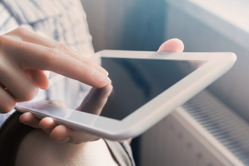 Woman Using White Business Tablet In Portrait View At Sunset