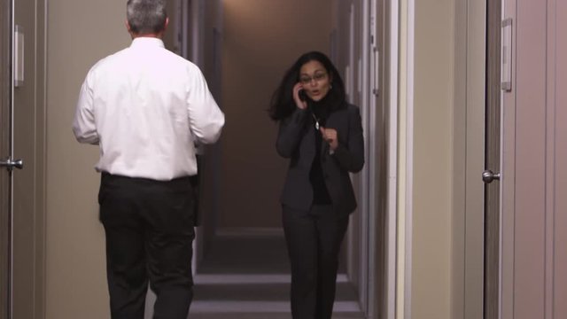 Office coworkers walking through hallway