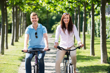 Smiling Couple Riding On Bicycles