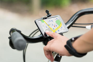 Finger Pointing At Smart Phone Showing GPS Navigation