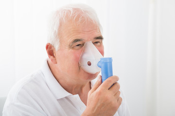 Man Inhaling Through Oxygen Mask