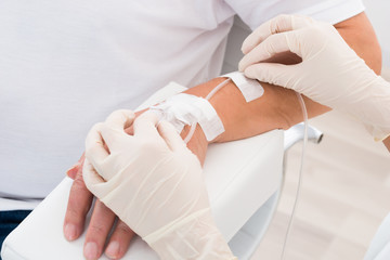 Iv Drip Inserted In Patient's Hand