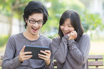 Couple Use Tablet at Park