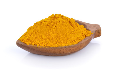 turmeric in wood spoon