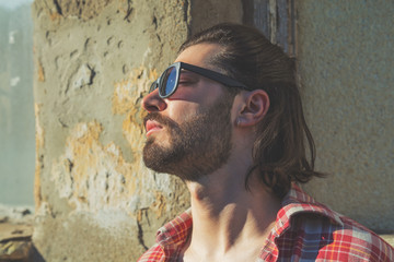 Young man posing in front of the camera.