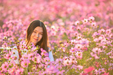 Woman and Cosmos flowers blooming in the garden