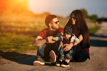 Fototapeta premium young family with a child on the nature