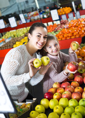 Fototapeta premium Mother and daughter buying apples .