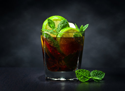  cocktail Cuba libre with lime and peppermint leaves