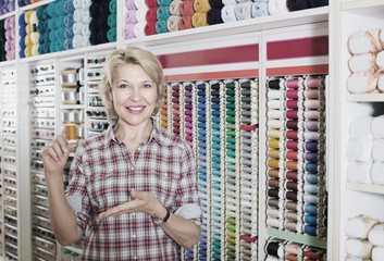 mature woman in sewing store.