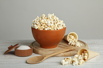Popcorn in bowl on wooden table