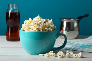 Popcorn in a cup on a wooden table