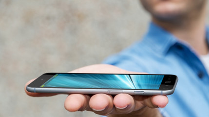 Businessman holding modern mobile phone