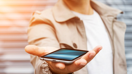 Businessman holding modern mobile phone