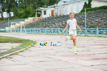 Little beautiful girl goes in for sports in the stadium