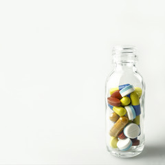 pills in the glass bottle and free space for background (medical concept)

