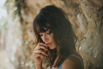 Portrait of sexual woman with eyes closed touching her lips