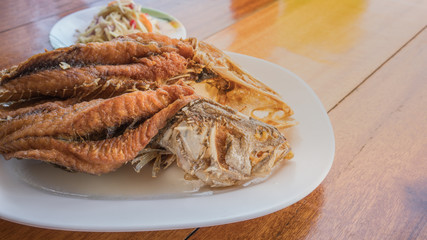 Crispy deep fried Sea bass with fish sauce and spicy raw mango salad