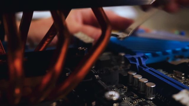 Setting up cooler to CPU processor at motherboard. 3840x2160