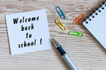 School supplies on teacher or pupil workplace background. Welcome back. Educational concept