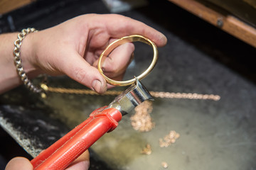 jeweler makes a piece of jewelry 