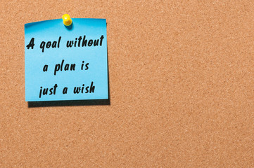 A goal without a plan is just a wish written by black marker on blue sticker pinned at notice board. Business, technology, internet concept. Stock Image