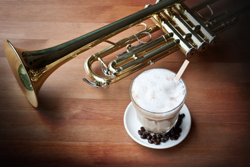 Coffee and Trumpet On Wooden Table