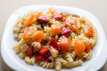 Italian pasta fusilli with vegetable sauce of peppers closeup