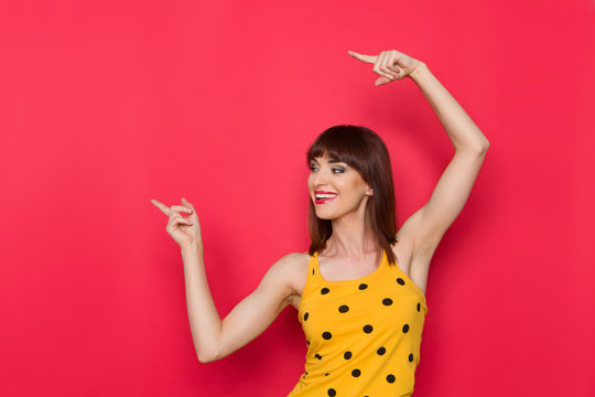Woman In Yellow Dotted Tank Top Pointing Away