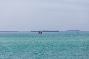Fototapeta premium Red Sails on Blue Horizon