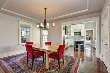 American dining room interior with table and red chairs