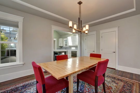 American dining room interior with table and red chairs