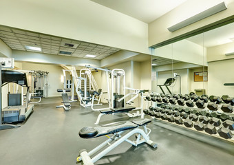 Fototapeta na wymiar Interior of new modern gym with sport equipment