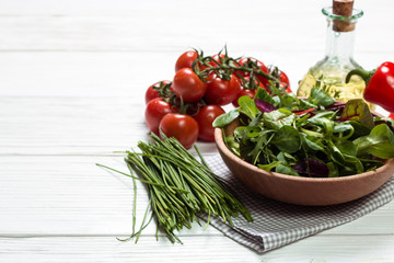 Fresh green salad with spinach ,ruccola,lettuce on wooden table.