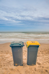 Two trash cans on the beach