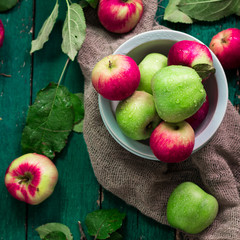 red and green apples on wooden vintage background