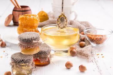 jar of honey with honeycomb on wooden table