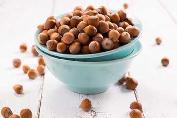 Hazelnuts on rustic wooden background